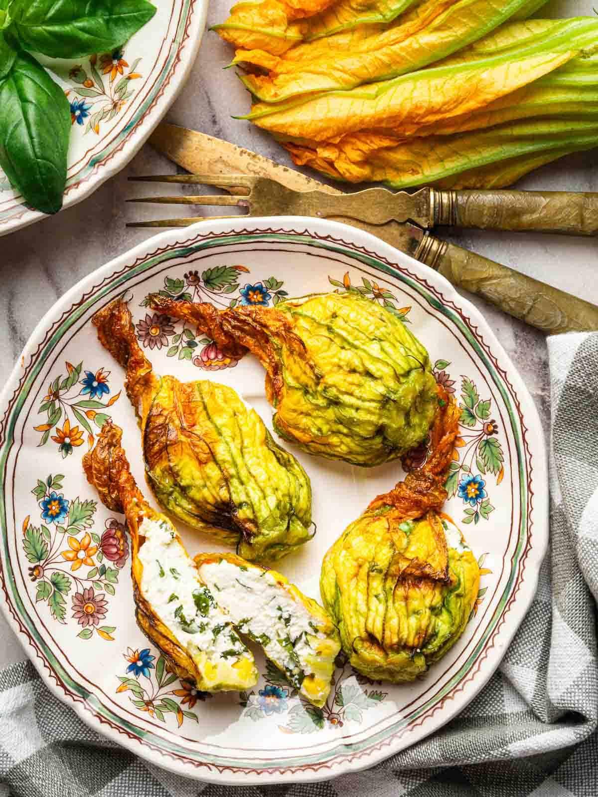 ratatouille stuffed zucchini blossoms served on a plate