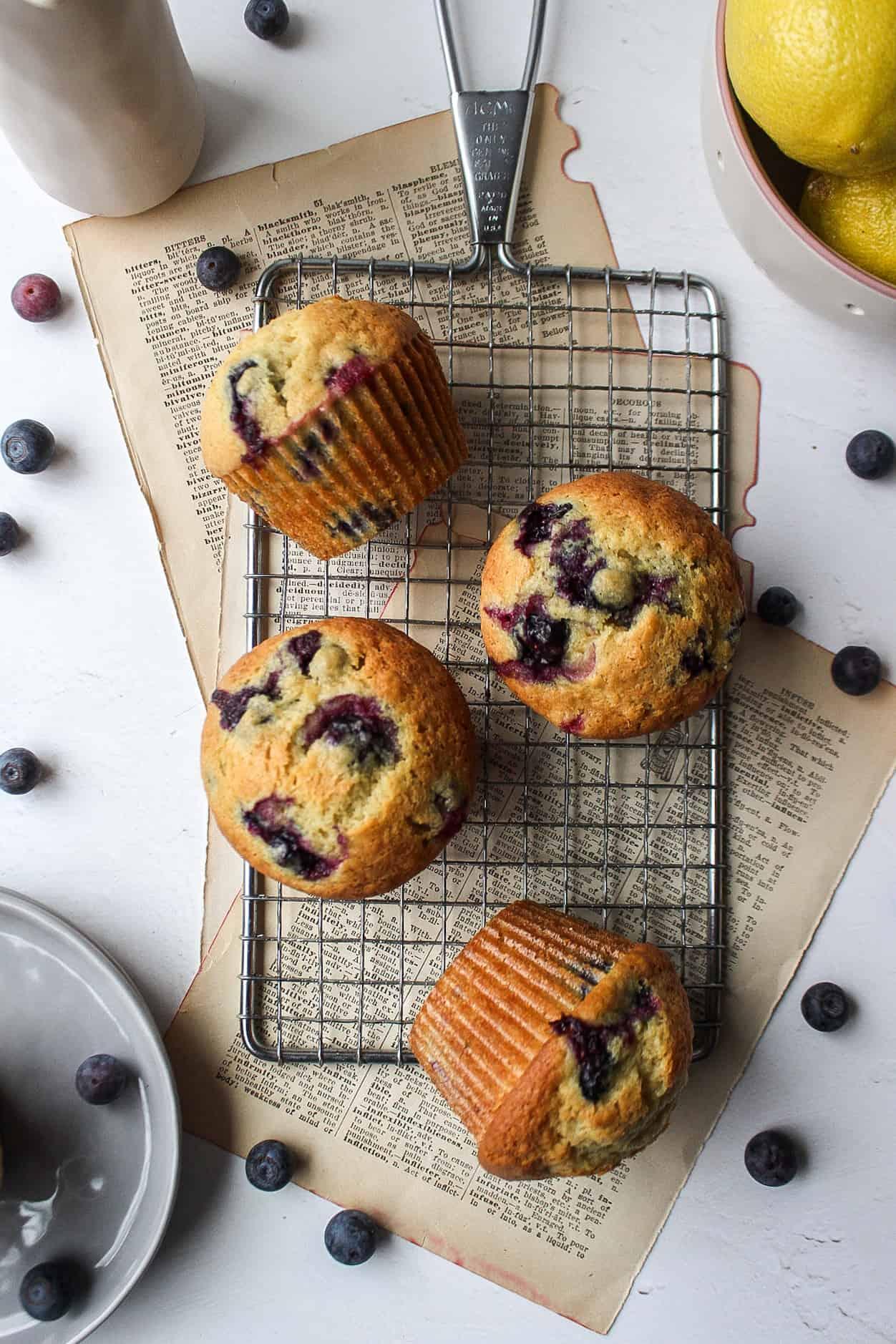 Close-up shot of lemon blueberry muffins on a cooling rack, showcasing their texture and vibrant colors