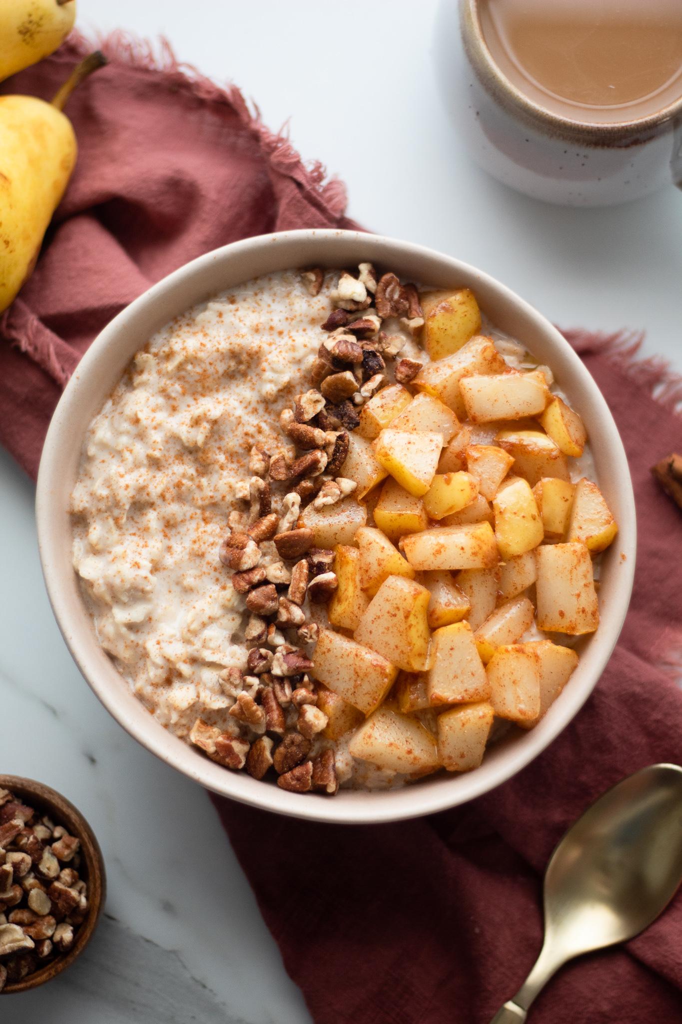 A warm bowl of spiced pear oatmeal with a sprinkle of cinnamon, styled in a cozy kitchen setting