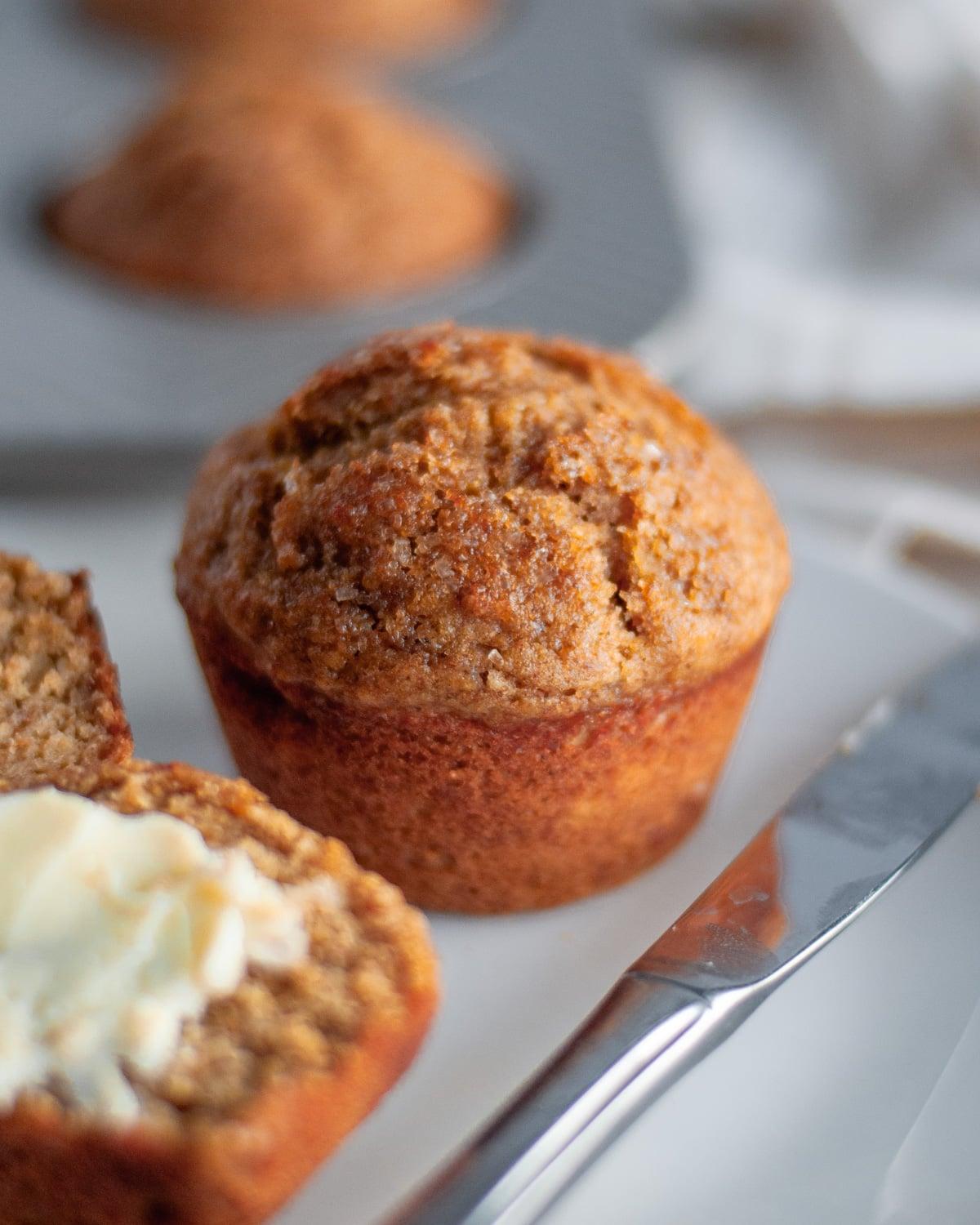 Close up of a single muffin, slightly crumbly and golden brown