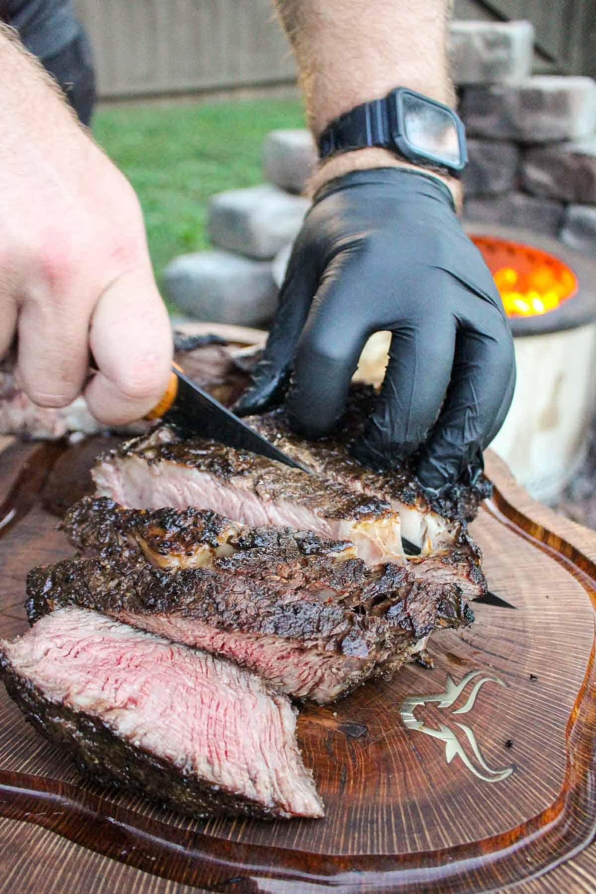 Person preparing a steak and sauce