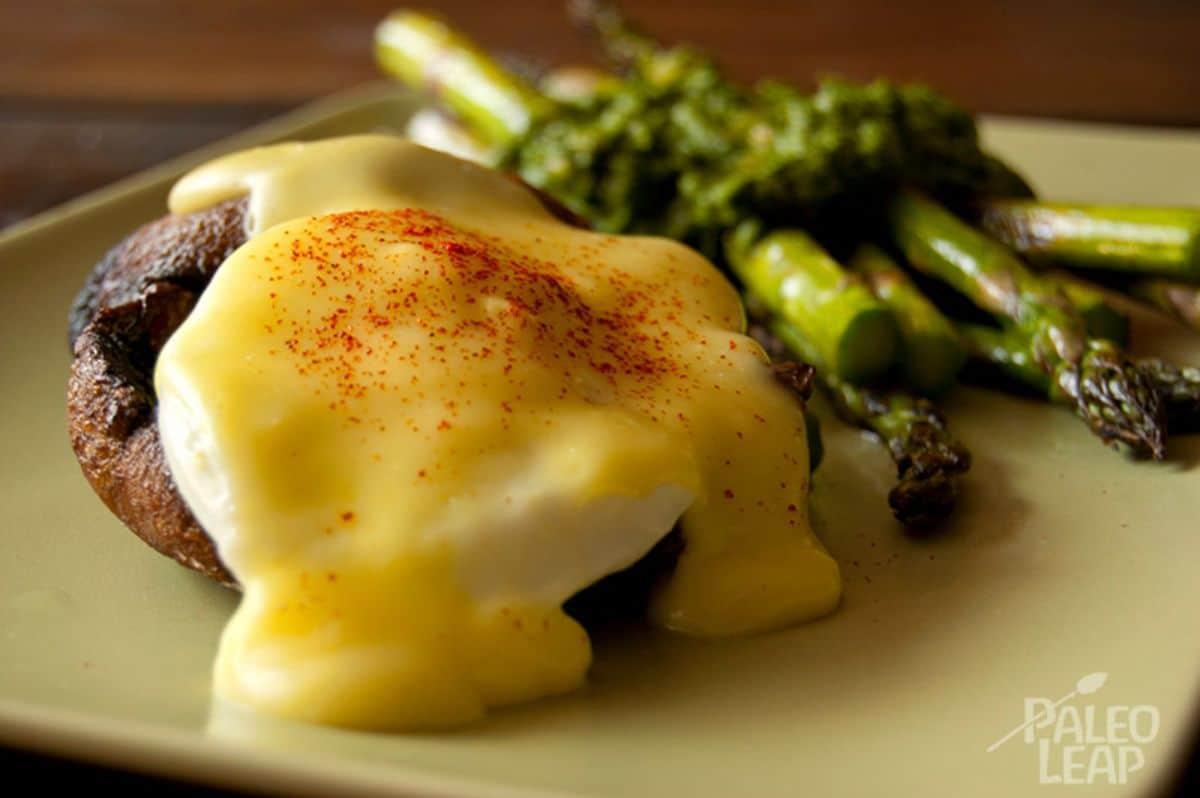 Overhead shot of St. Patrick's Day Eggs Benedict on a plate with a sprig of parsley