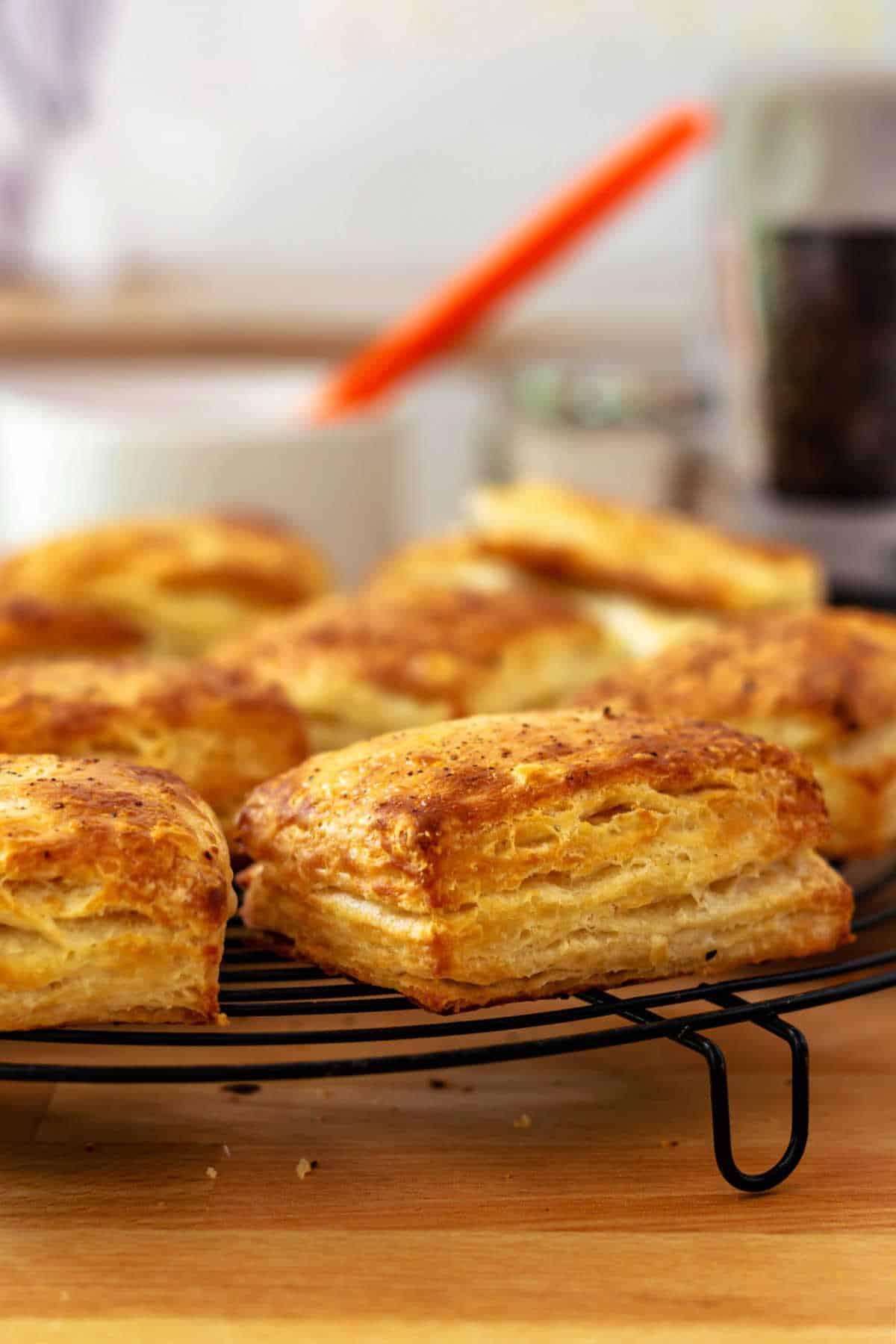 golden brown savory wheat and cheese biscuits on a wire rack