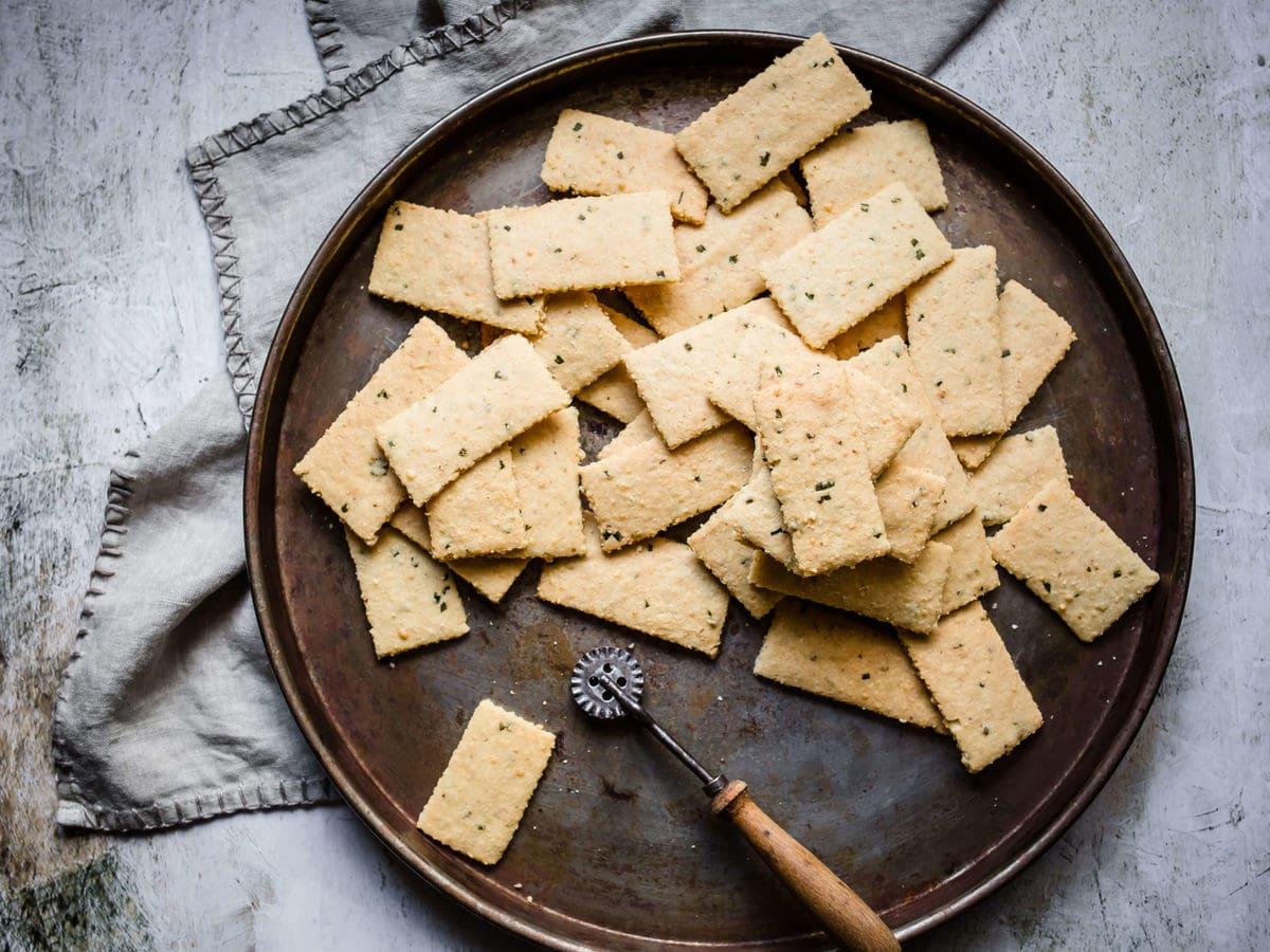 crispy keto garlic parmesan crackers on a wooden board