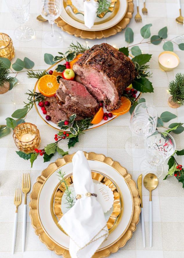 A table set for a dinner party, with the roasted beef as the centerpiece
