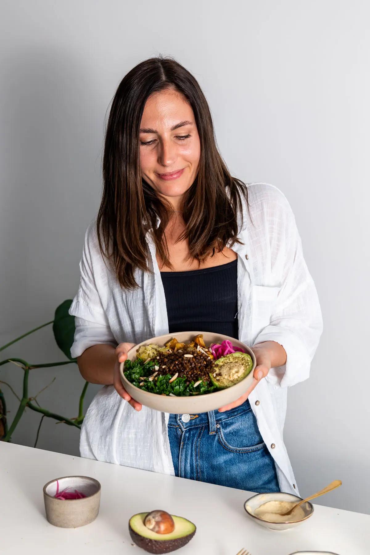 A person happily eating a bowl of Lentil Oatmeal