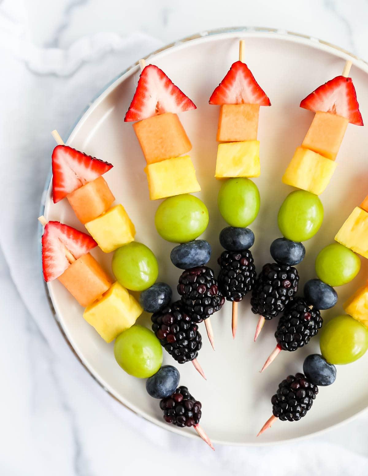 Colorful star fruit kebabs on a platter