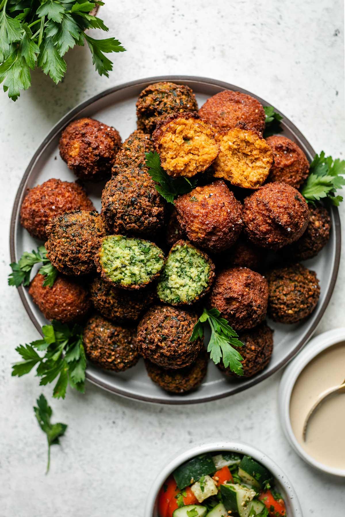 Close-up shot of crispy falafel balls with a side of chipotle aioli