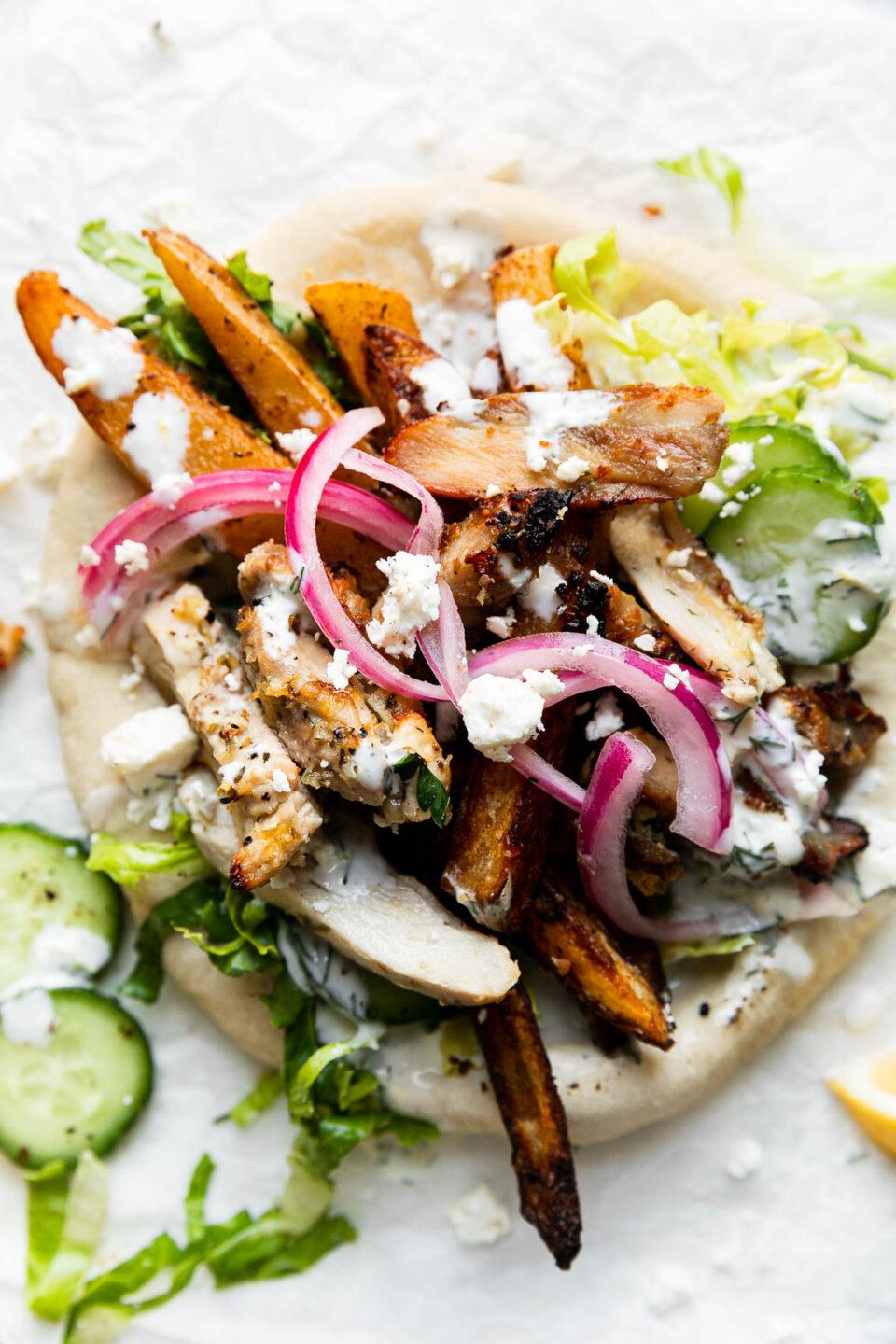 various ways to serve sweet basil tzatziki (pita bread, vegetables, grilled chicken)