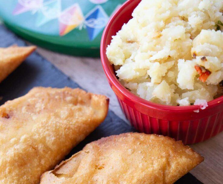 a close-up shot of an empanada filling made of mashed potatoes, sour cream, and chives