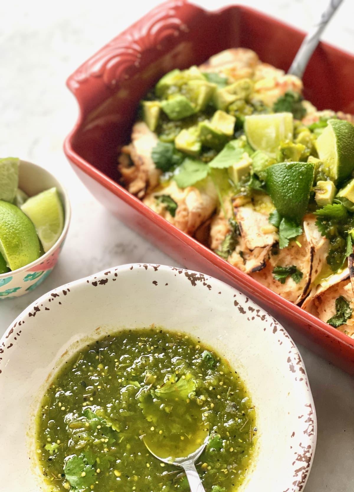 Close up of the vibrant green salsa verde being spooned onto the burrito