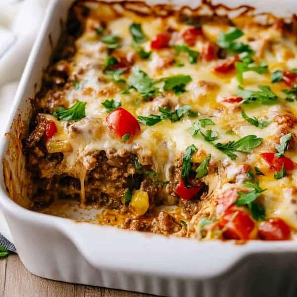 A family gathered around a table, enjoying the Philly Cheesesteak Casserole