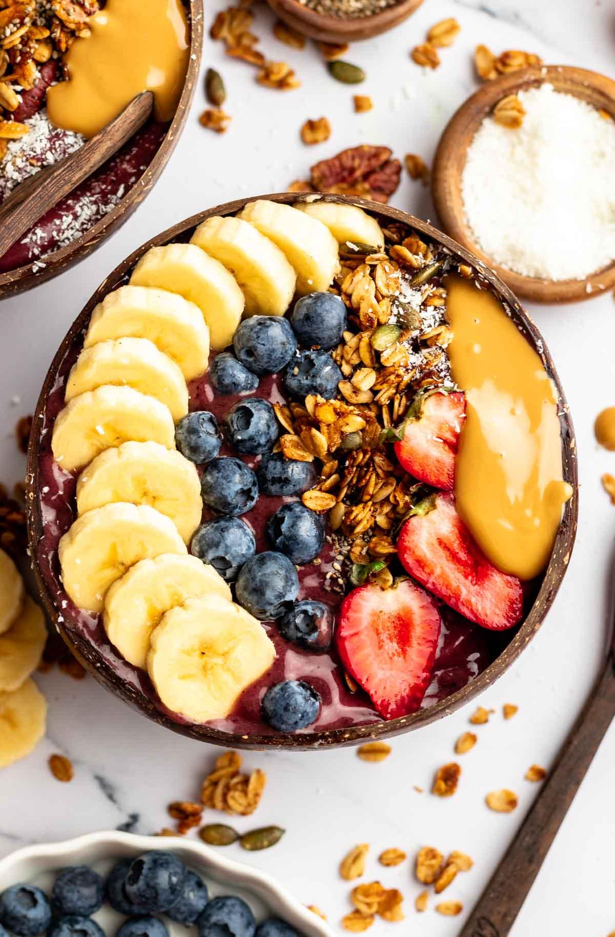 Vibrant and visually appealing almond and acai power bowl with various toppings