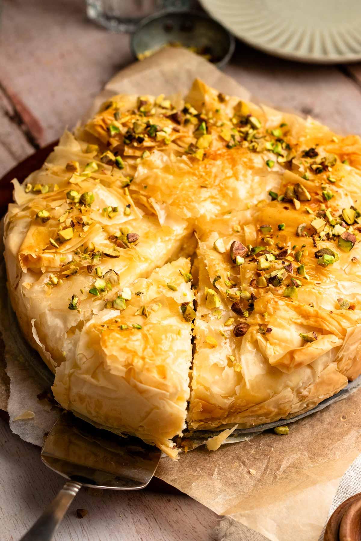 Close-up shot of a piece of baklava with cream cheese filling, showcasing its layers and texture