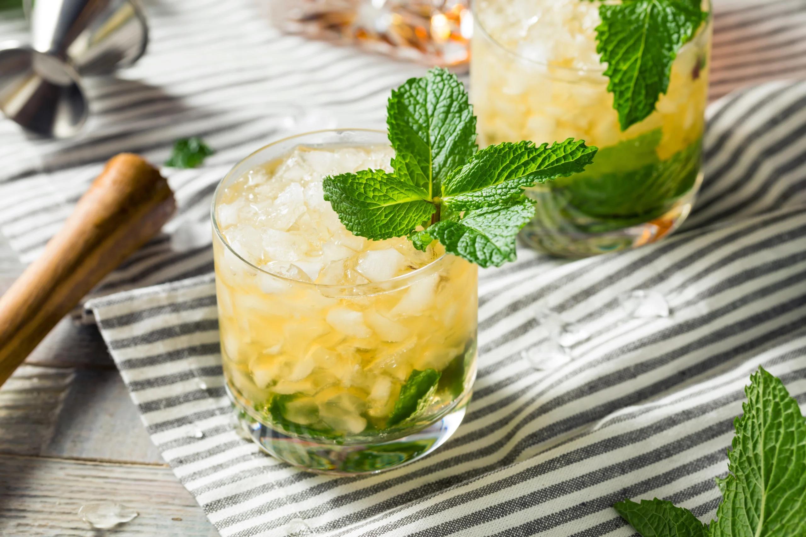 close up shot of mint julep wings on a platter with a mint garnish