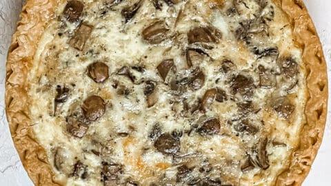 Close-up of sliced Smoked Tilsit and Mushroom Quiche showing the layers