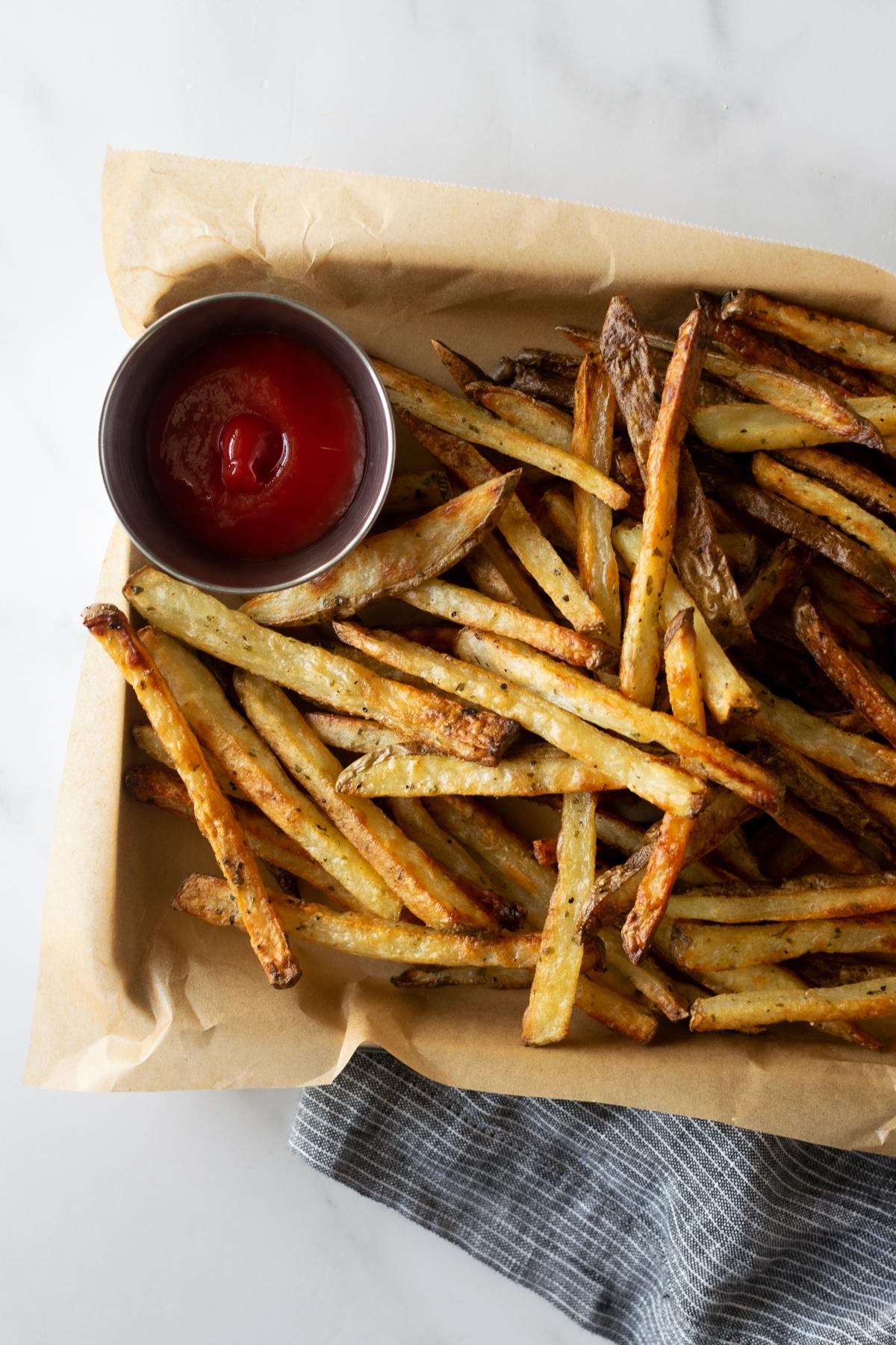 golden brown, crispy French fries on a baking sheet
