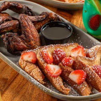 A table set for a party with a plate of Buffalo Chicken French Toast in the foreground