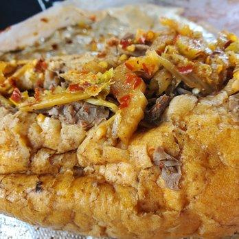 close up of a spicy beef roti bomb being cut open, showing the filling