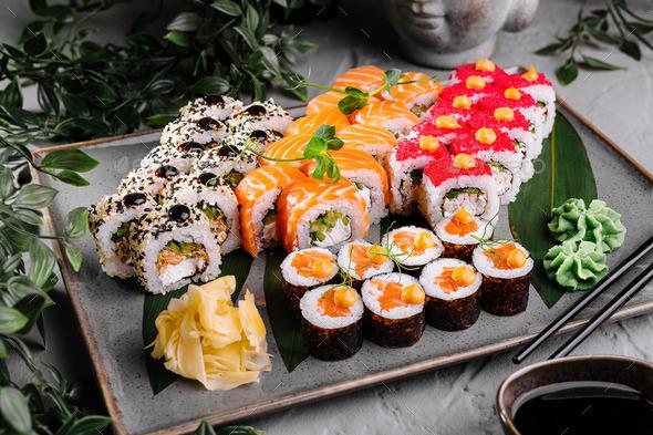 A vibrant table setting with several Sushi Roti and various dipping sauces