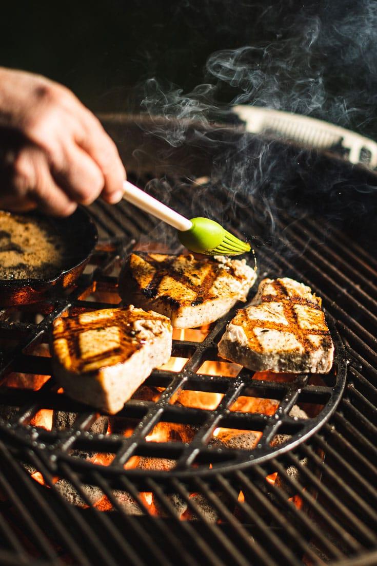 Person enjoying grilled swordfish on a summer patio