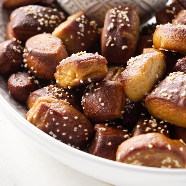 A close up shot of the finished beer pretzel bites with raspberry glaze, looking delicious and enticing