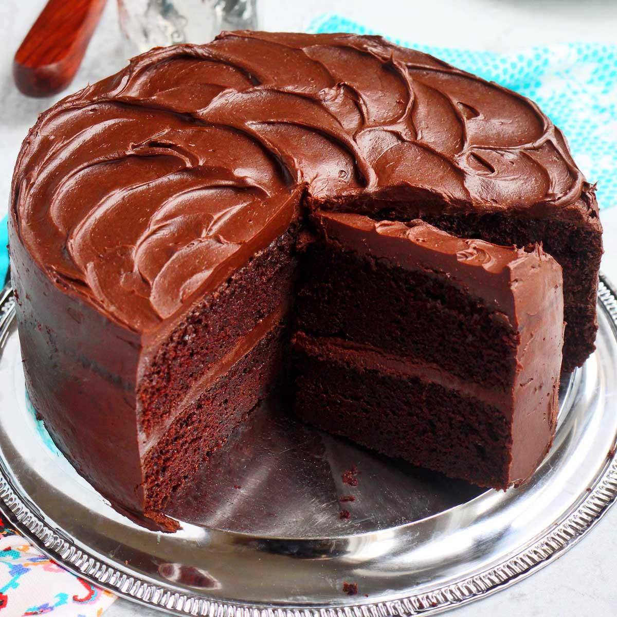 Close-up shot of a moist, maroon-colored cake with a rich, glossy glaze