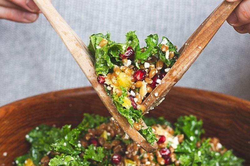 A person enjoying a large bowl of the wheat berry and kale salad