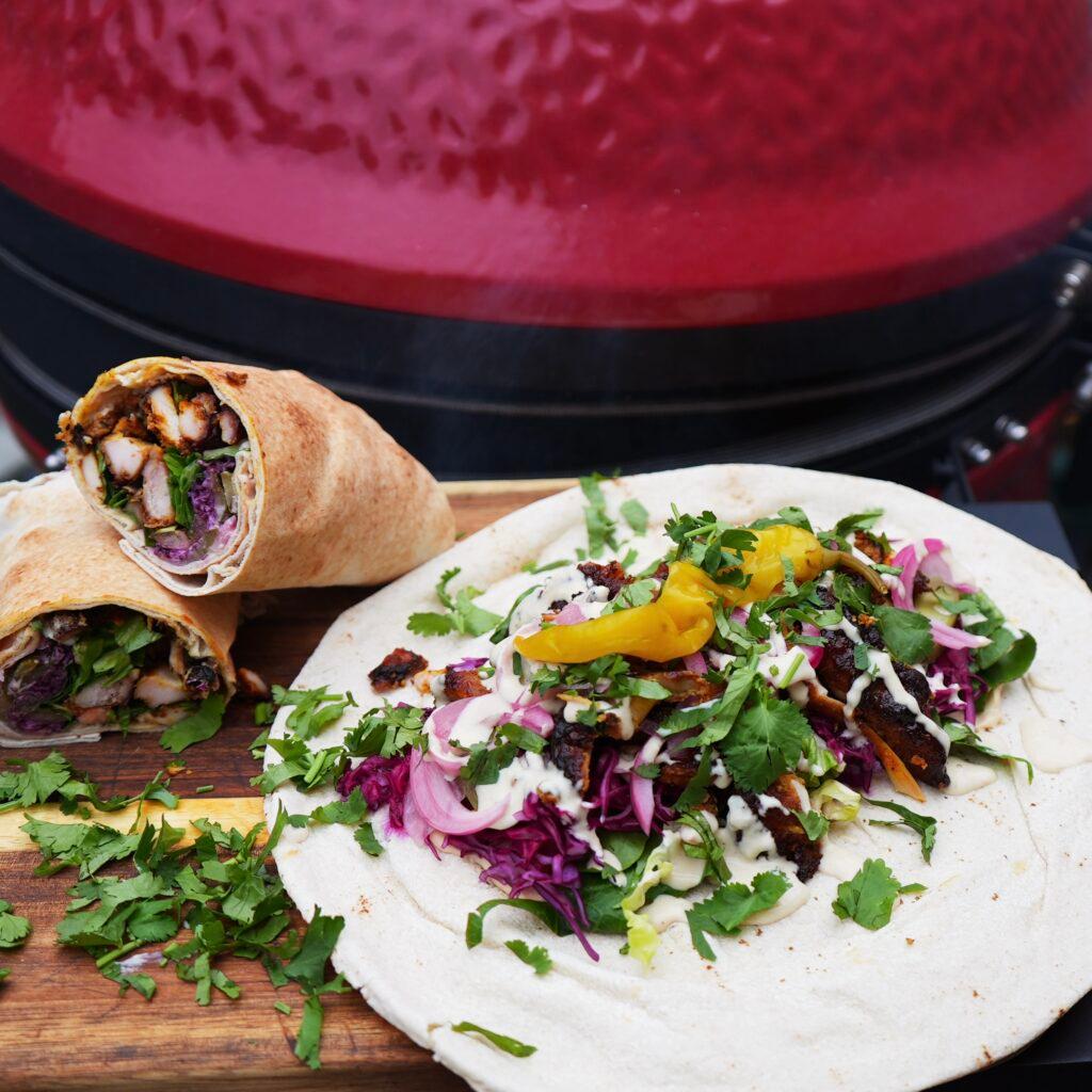 A vibrant platter of Mexican Shawarma, showcasing the juicy chicken, creamy guacamole, and fresh toppings.