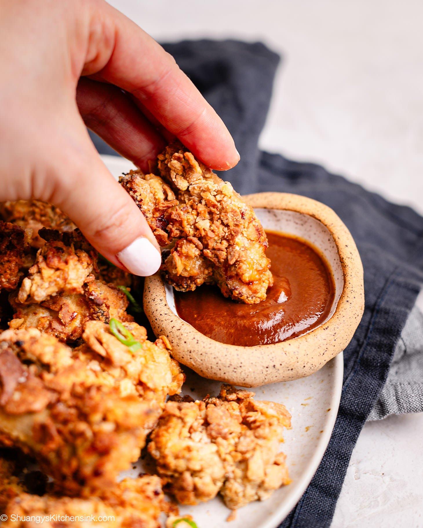 A plate of homemade Chinese chicken nuggets with a dipping sauce.