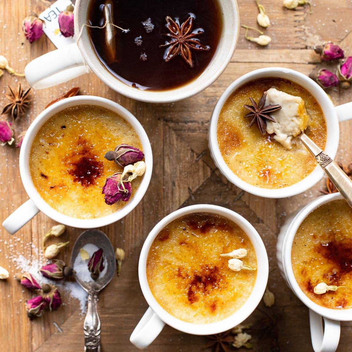 A beautifully lit table setting with a serving of Chai Crème Brûlée with Cardamom