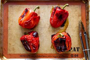 Top-down view of baking sheets with pepper peels baking in the oven