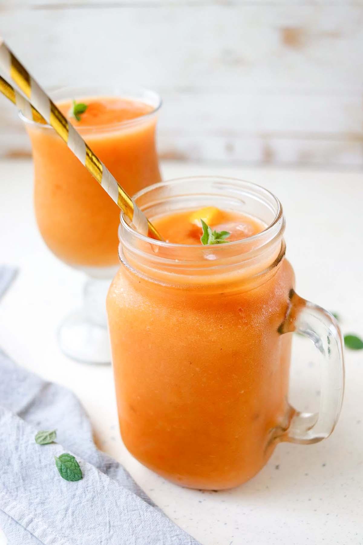 overhead shot of tropical mango tango smoothie in a glass