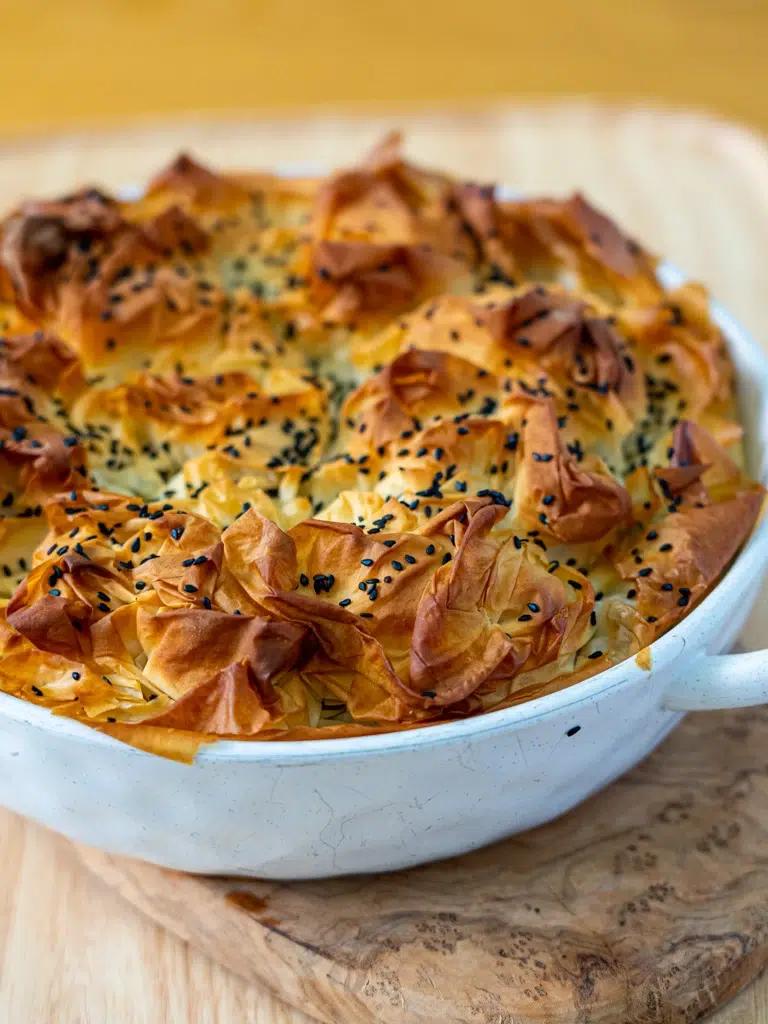 golden brown spanakopita baking dish, close-up