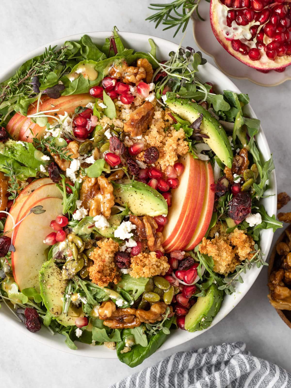 A vibrant quinoa salad with apples, nuts, and a drizzle of cinnamon-honey dressing