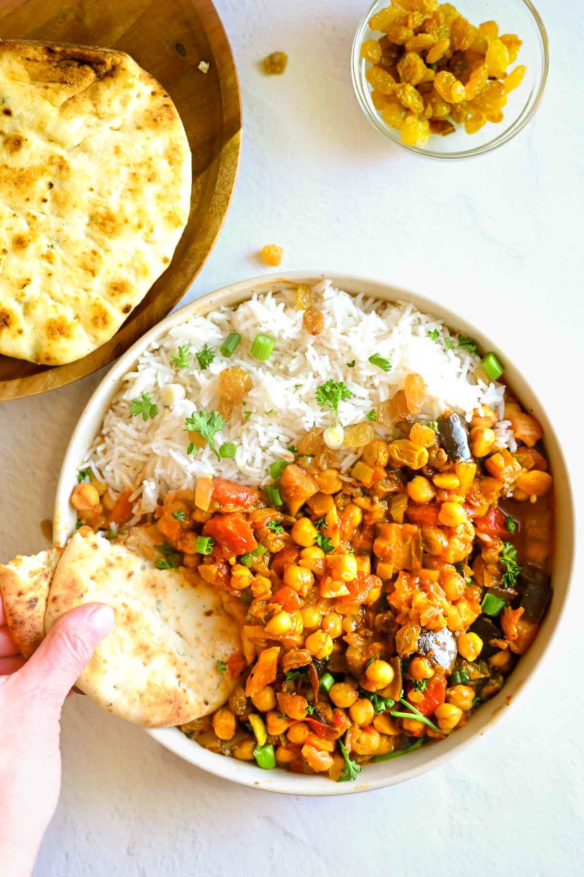 a bowl of chickpea tagine oatmeal with a spoon scooping a bite