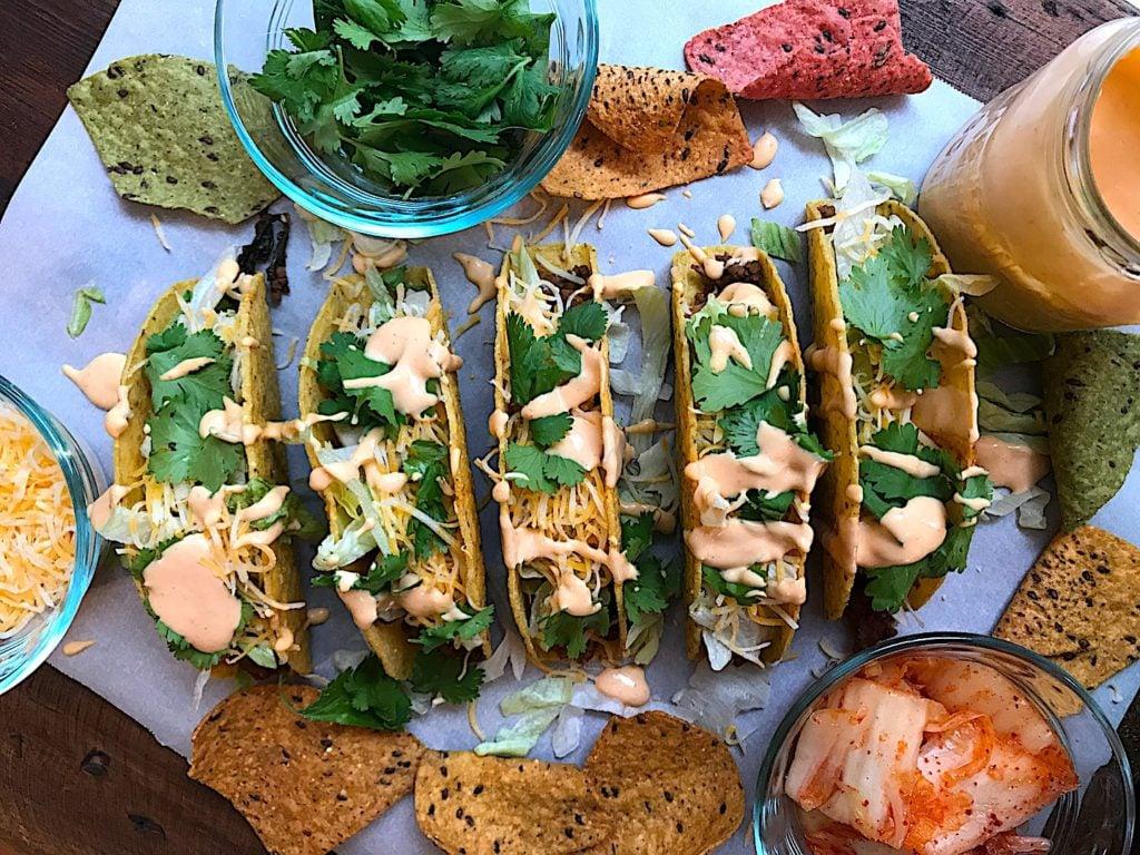 Kimchi and Crab Tacos with Spicy Mayo on a rustic wooden table