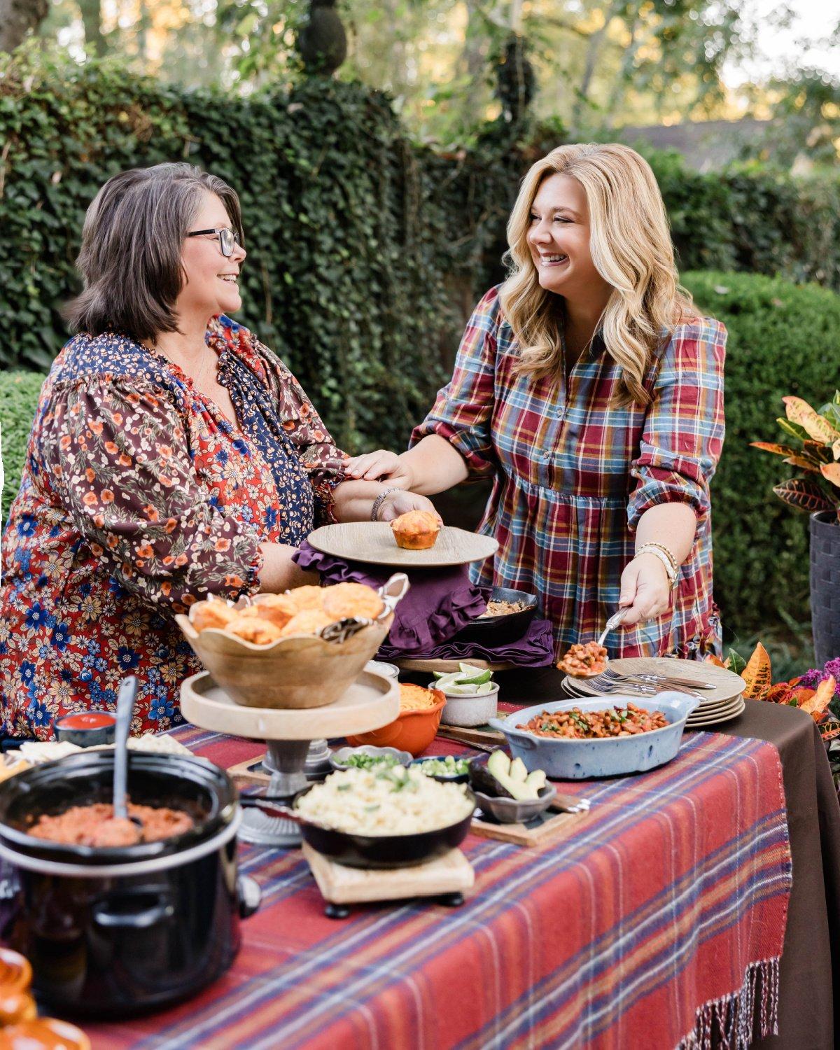 A family gathered around a table enjoying a bowl of chili and cornbread