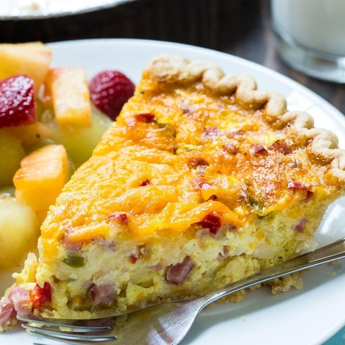 Denver Omelet Quiche, a golden-brown baked quiche with visible bacon, onions, peppers, and cheese filling