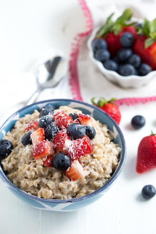 Close-up shot of a creamy coconut oatmeal with fresh berries and nuts