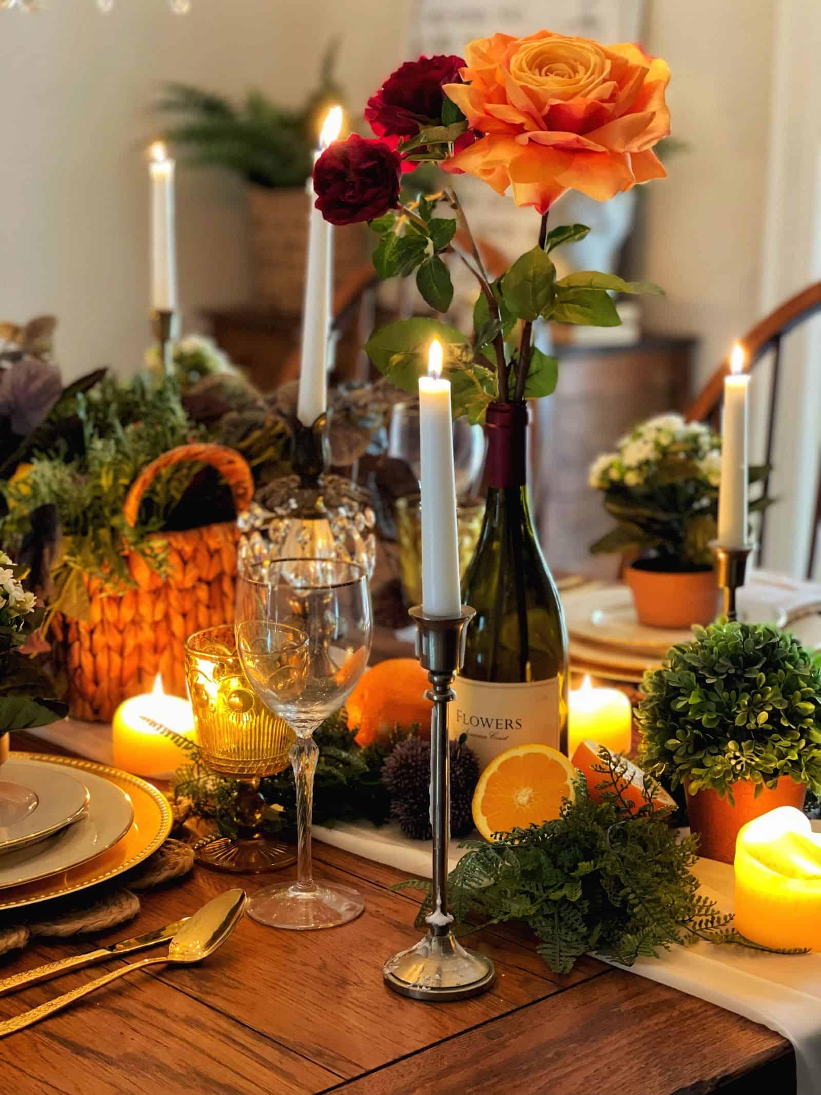 A rustic table setting with a plate of bruschetta, wine glasses, and candles