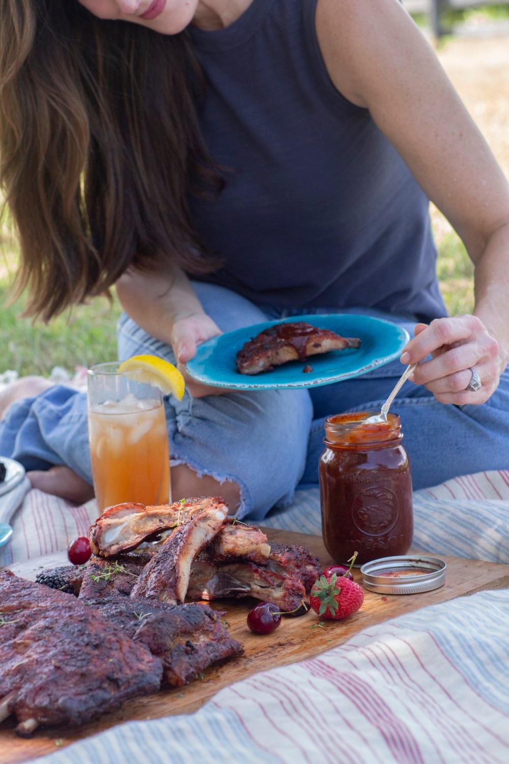 A family enjoying a meal of smoked ribs outdoors