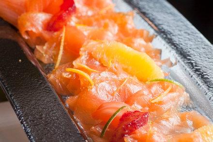 overhead shot of a whole saffron and lemon gravlax being cured in a dish