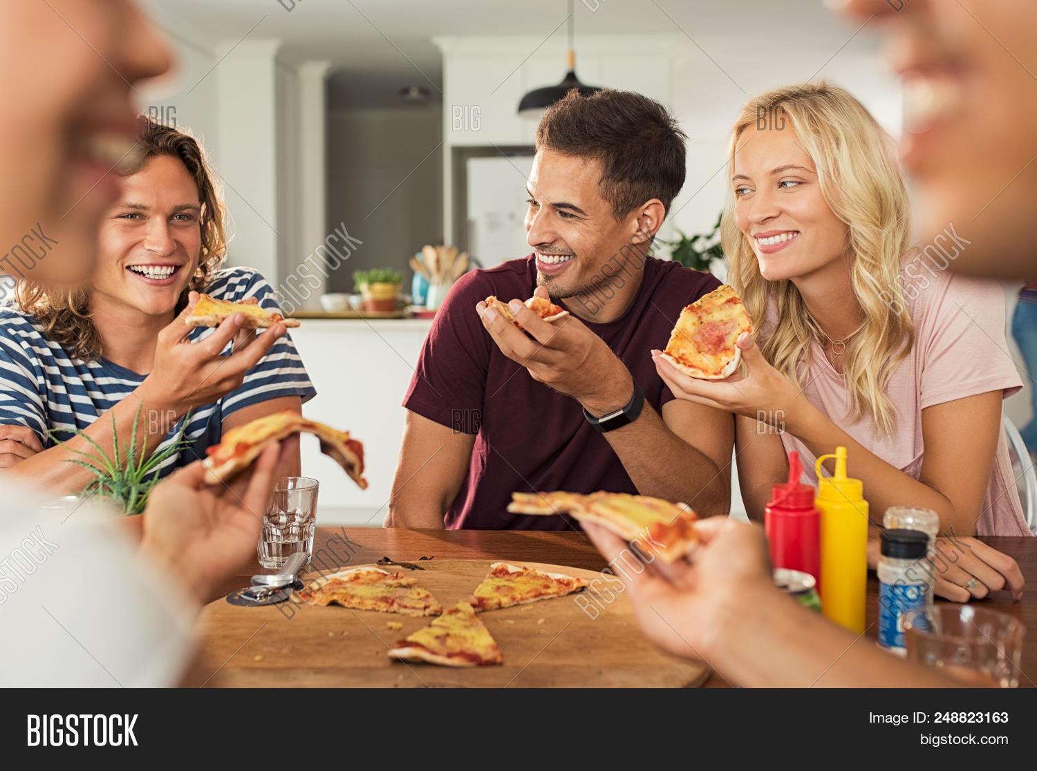 A group of friends enjoying mini pizzas together