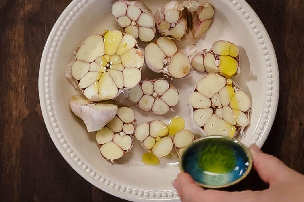 Steamed garlic cloves drizzled with olive oil and herbs