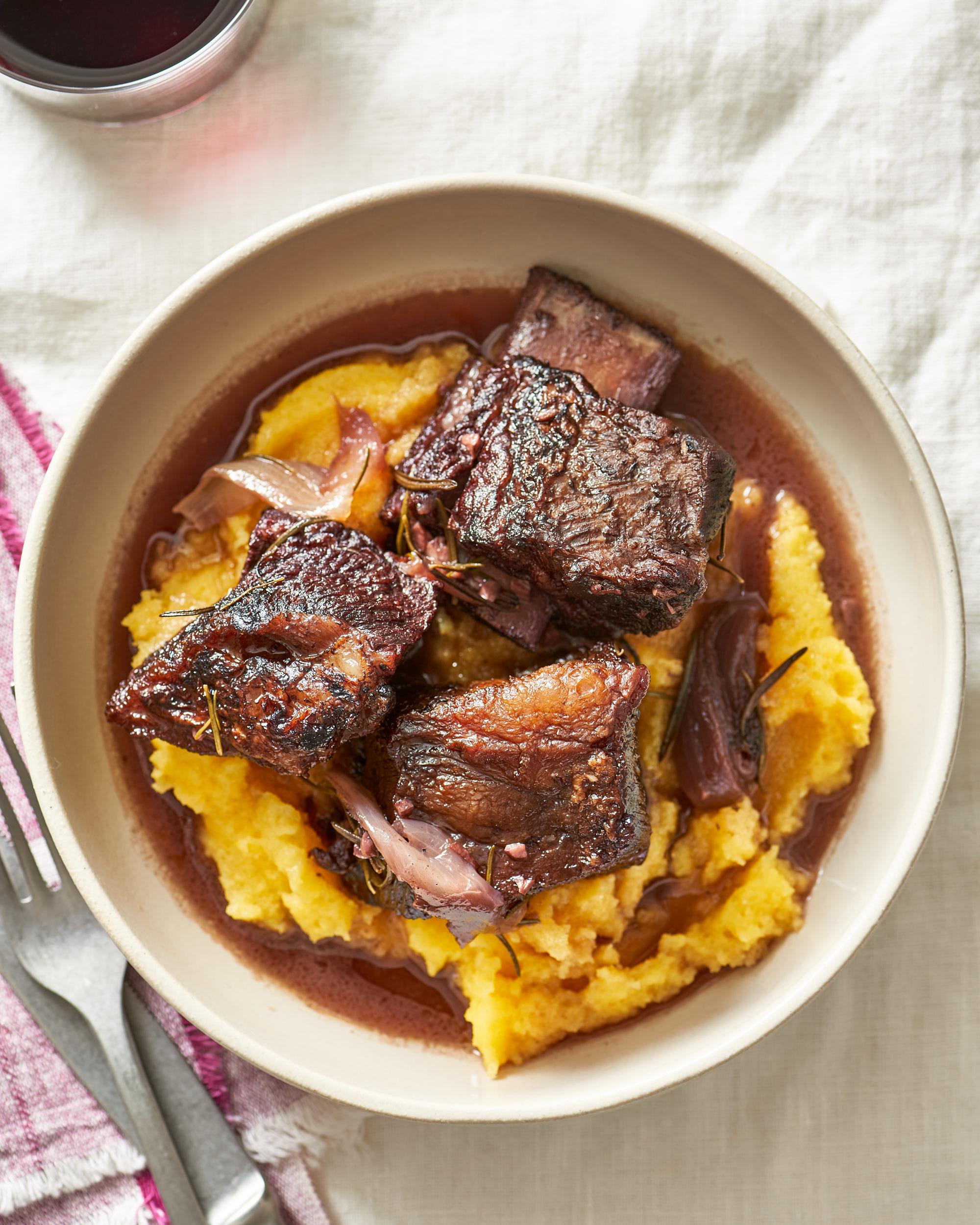beef short ribs being seared in a dutch oven