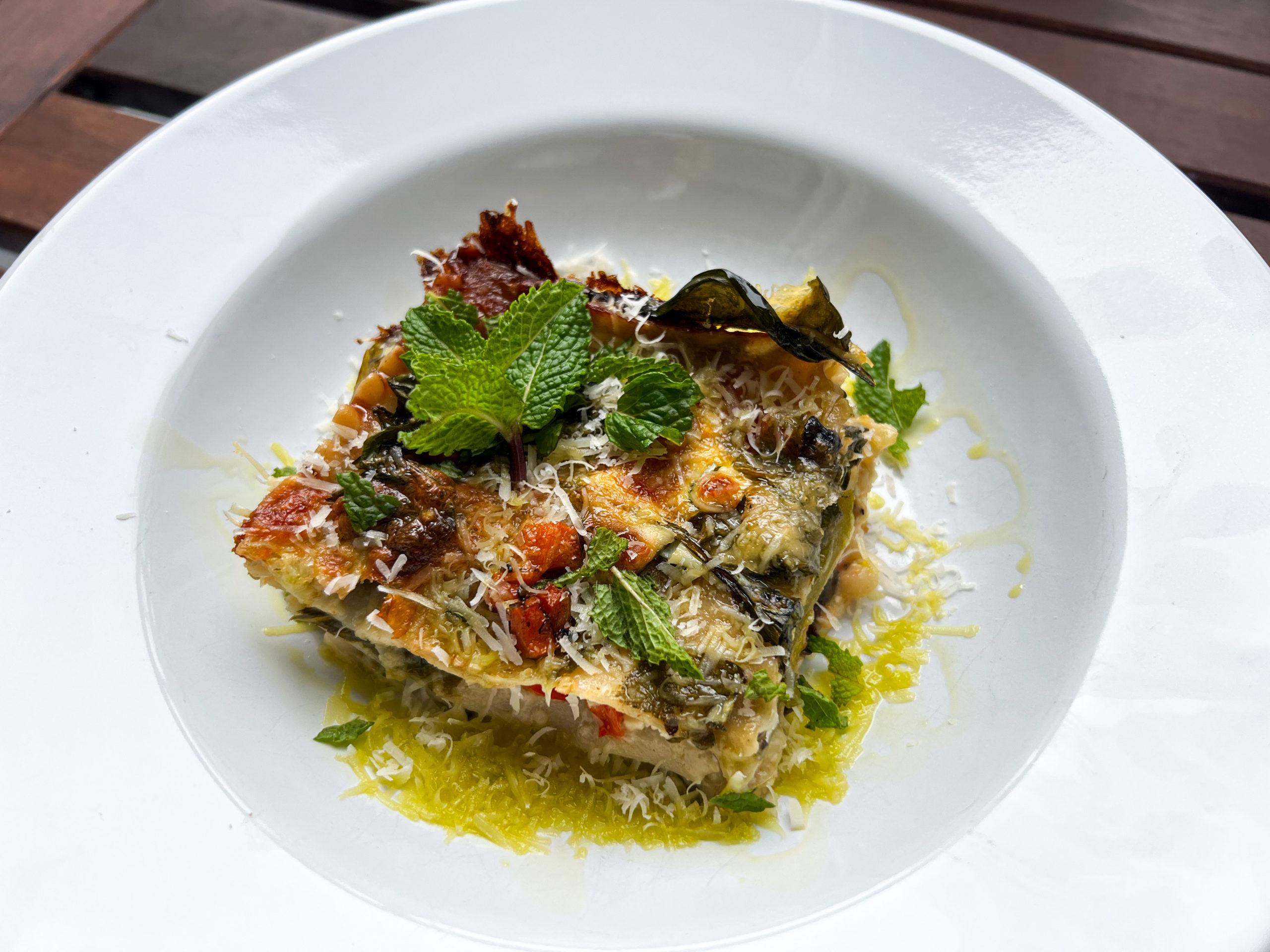 Close-up shot of a freshly baked Wheat and Spinach Lasagna, highlighting the layers and texture.