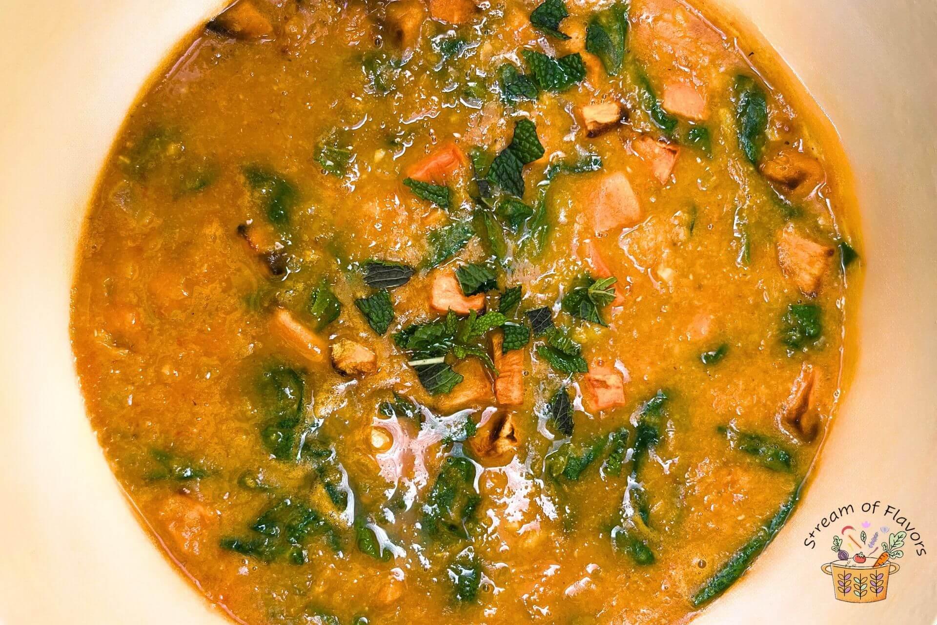 aerial view of a steaming bowl of Moroccan lentil soup