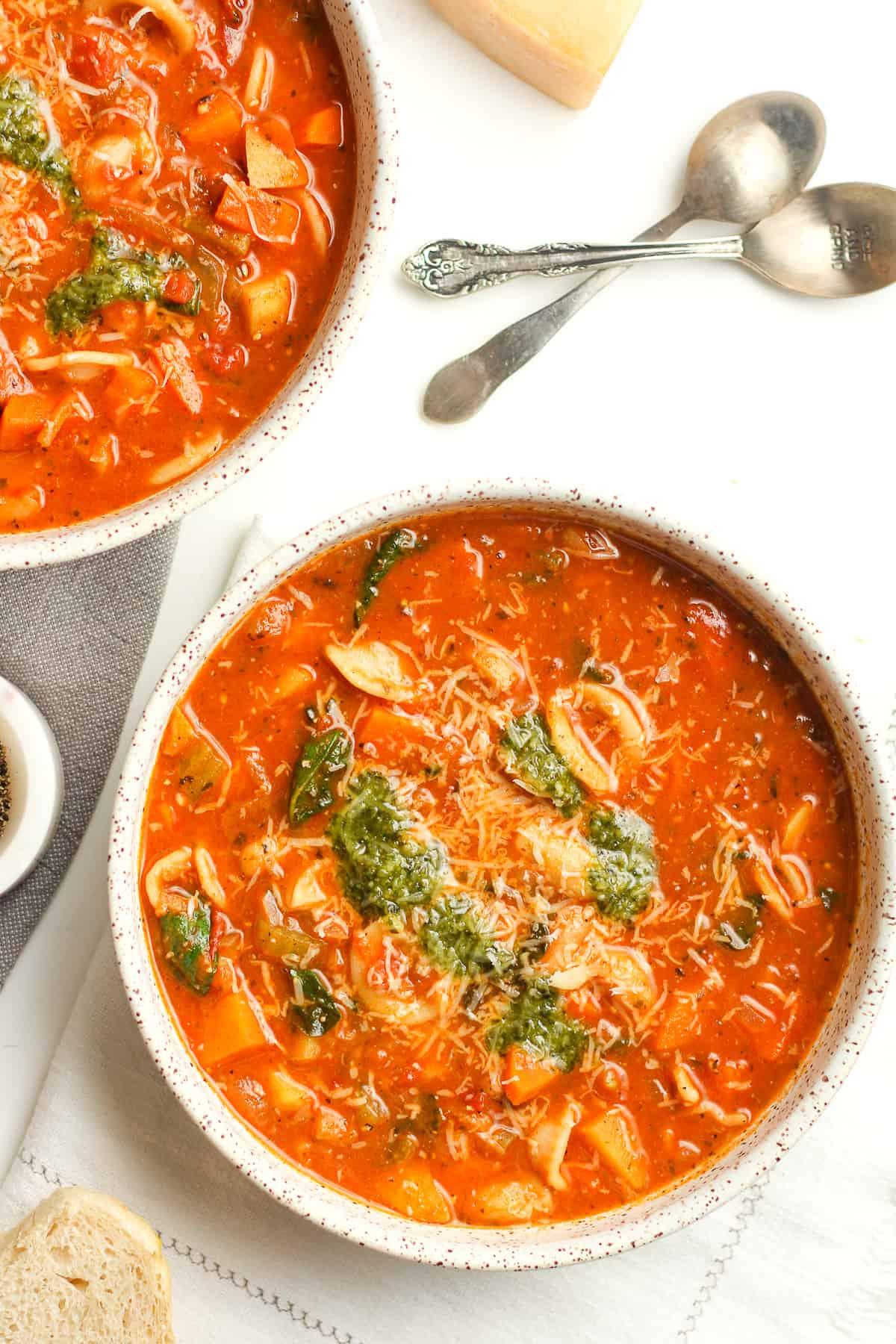 minestrone soup garnished with pesto and parmesan