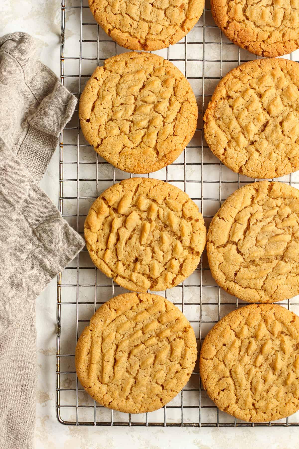 Close-up shot of a stack of freshly baked peanut butter cookies on a baking sheet